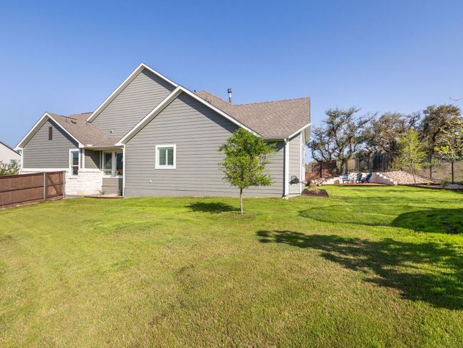 Back of property featuring a yard, fence, and roof with shingles | Image 19