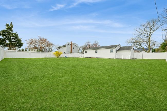 View of yard featuring a fenced backyard | Image 19