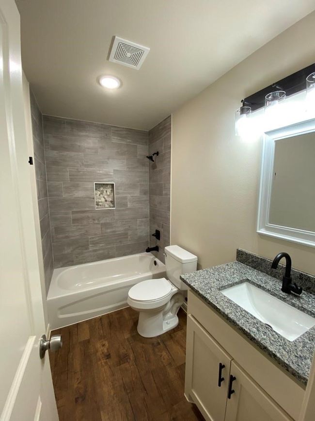 Bathroom with wood finished floors, vanity, toilet, shower / bath combination, and recessed lighting | Image 13