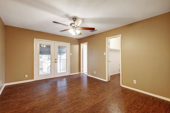 The primary bedroom has a private rear porch and larger walk-in closet - notice the wood floors? | Image 19