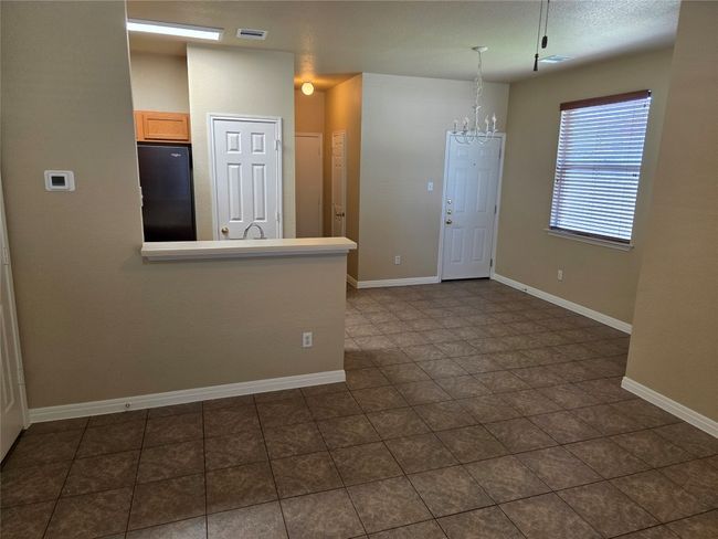 Unfurnished room with a chandelier and baseboards | Image 8