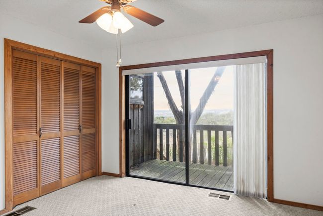 Unfurnished bedroom featuring carpet, access to exterior, a closet, and a ceiling fan | Image 25
