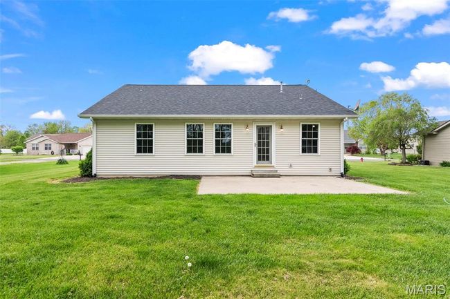 Rear view of house featuring roof with shingles, a yard, and a patio area | Image 30