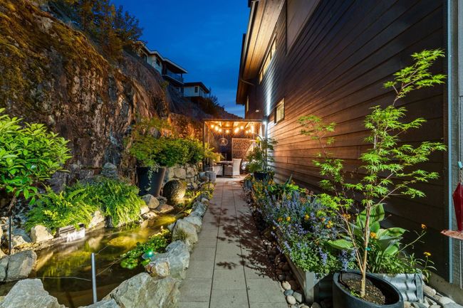 View of property exterior with a small pond and a patio area | Image 19