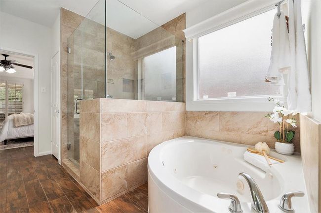 We love the design of this of half wall, oversized, glass enclosed shower, for its added privacy! Or maybe bubbles are more your speed to wash away the cares of the day! | Image 14