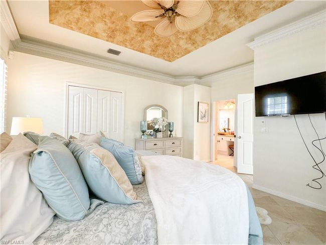 Bedroom featuring ornamental molding, a closet, light tile flooring, and ceiling fan | Image 47