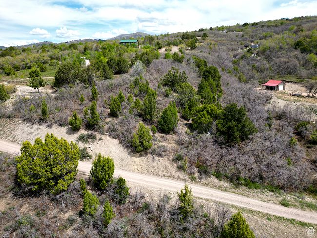 Aerial view of sparsely populated area with a mountain backdrop | Image 23