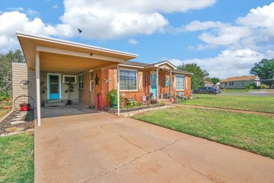 View of front facade with a carport and a front yard | Image 3