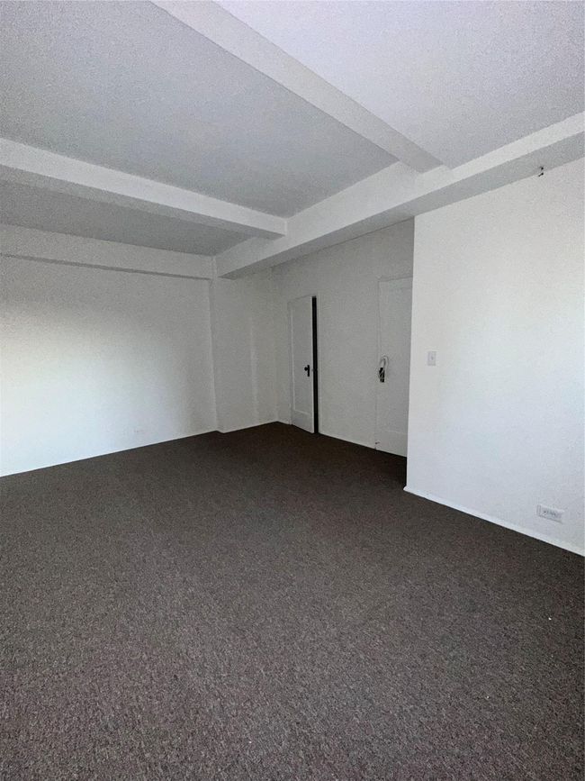 Spare room featuring dark carpet | Image 13