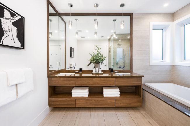 Full bath with baseboards, double vanity, a stall shower, a bath, and a sink | Image 24
