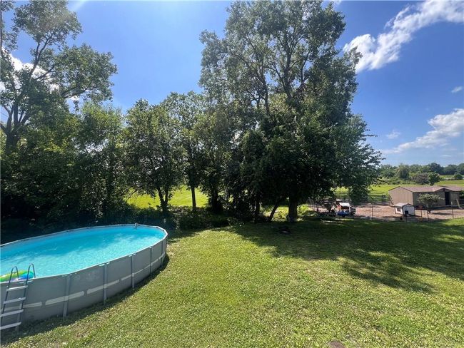 View of green lawn featuring an outdoor pool | Image 38
