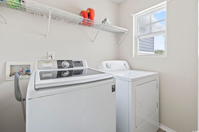 Laundry area featuring washer and clothes dryer and plenty of natural light | Image 23