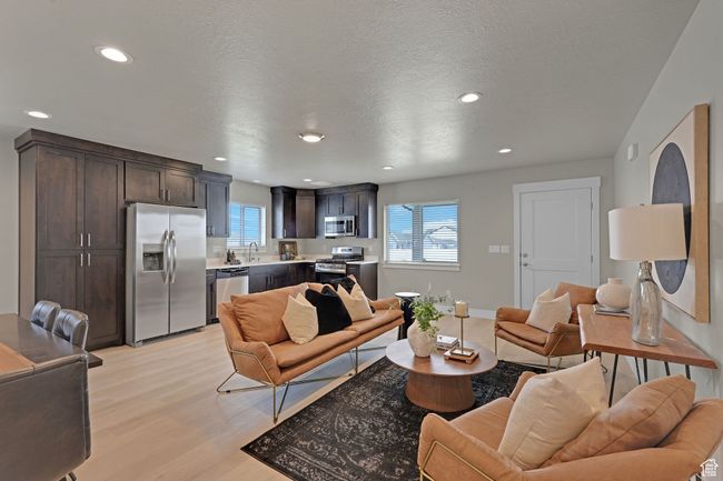 Living area with light wood finished floors and recessed lighting | Image 6