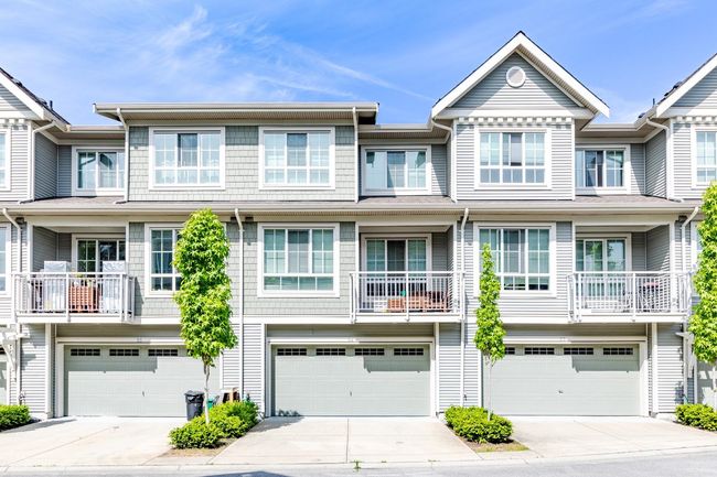 Multi unit property featuring an attached garage and concrete driveway | Image 35