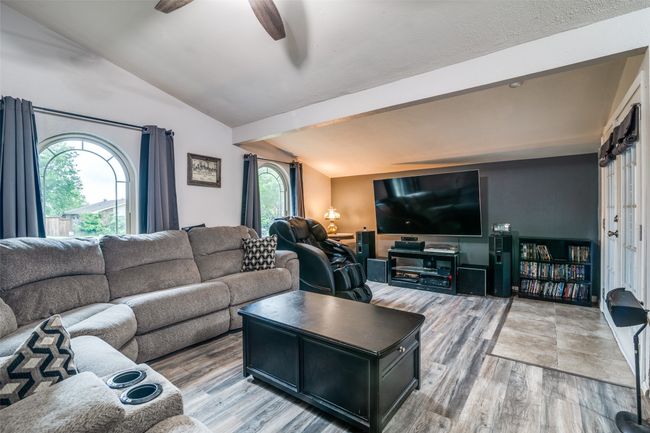 Living area with light wood-style floors and a ceiling fan | Image 4