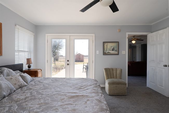 Carpeted bedroom featuring french doors, access to exterior, ornamental molding, and a ceiling fan | Image 18