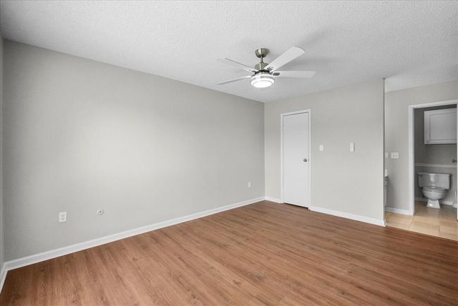 Nice-sized master bedroom with a connected bathroom, comfort meets convenience | Image 19