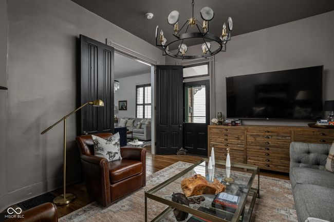 Den with hardwood floors, a chandelier, fireplace - could also be used as a 3rd bedroom. | Image 8
