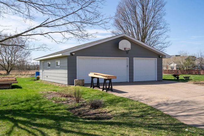 The oversize garage uses the 3rd stall as a heated workshop | Image 35