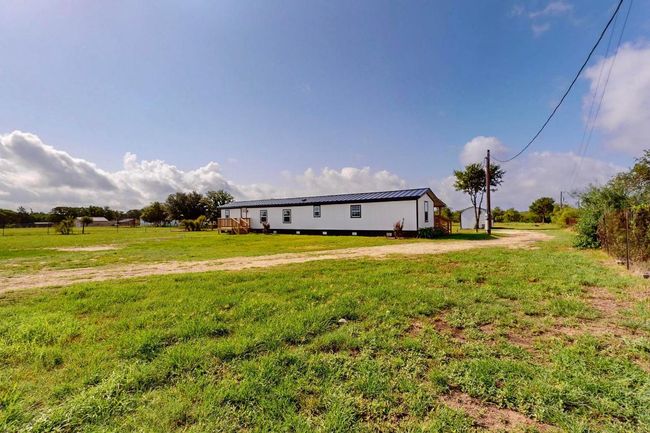 View of grassy yard with a view of countryside | Image 10