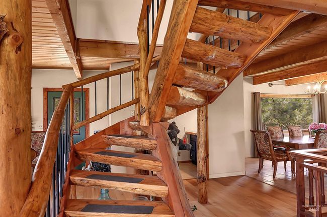 Stairs with beamed ceiling and wood finished floors | Image 5