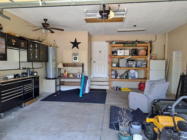 2.5 car garage. Wall shelving stays and outside Fridge stays for your convenience. | Image 25