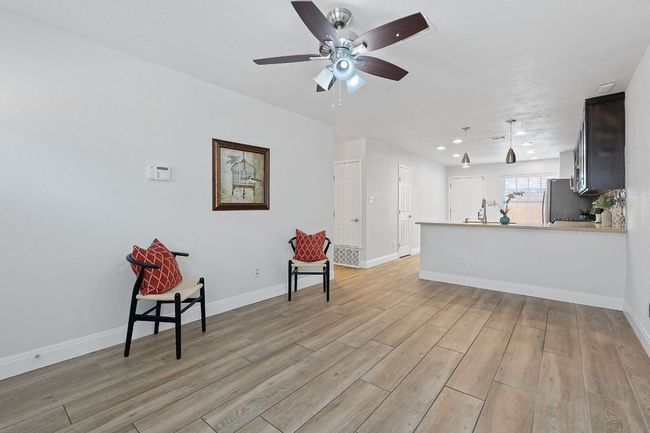 Living area featuring ceiling fan, light wood-style flooring, and recessed lighting | Image 10