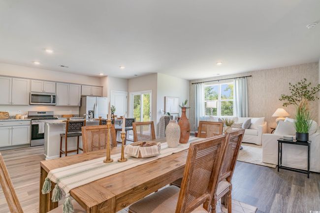 Dining space featuring light wood-style floors, recessed lighting, and wallpapered walls | Image 8