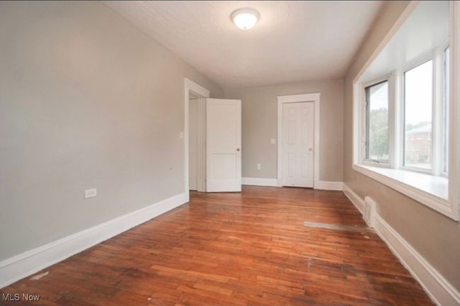 Empty room with hardwood / wood-style floors and baseboards | Image 5