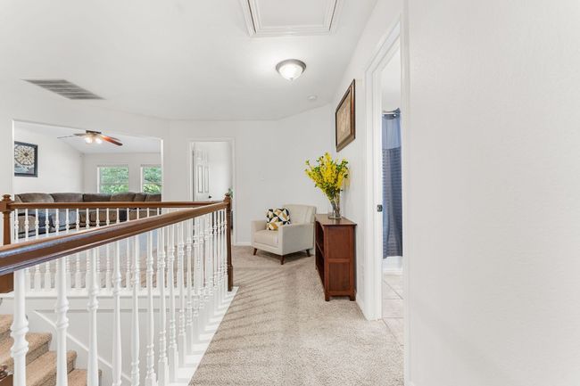 Corridor with light carpet, baseboards, and an upstairs landing | Image 26