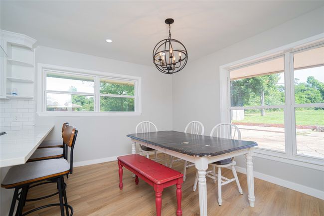 Dining area with a chandelier, light wood finished floors, and recessed lighting | Image 14