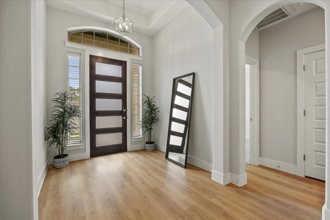 Grand entry includes beautiful flooring, arched doorways, towering ceilings and tall baseboards | Image 6