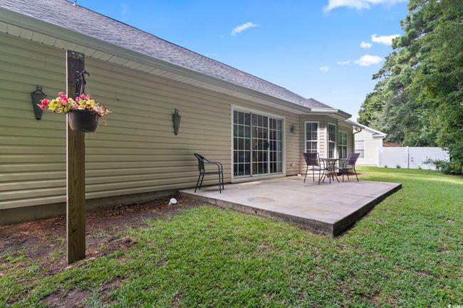 Back of property featuring a shingled roof and a patio | Image 28
