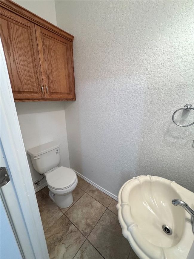 Bathroom with toilet and tile patterned floors | Image 37