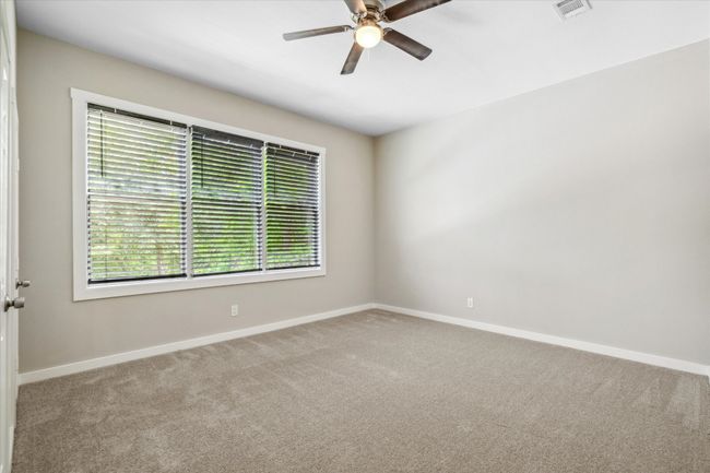 Unfurnished room featuring carpet, baseboards, and ceiling fan | Image 32