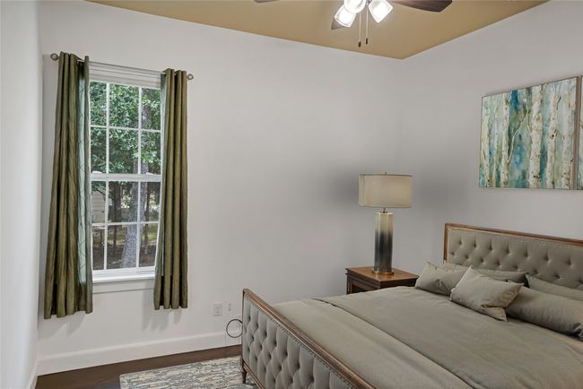 Bedroom with baseboards and dark wood-style flooring | Image 18