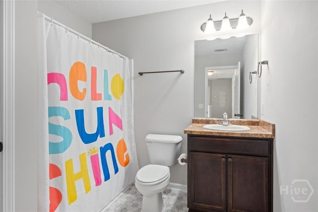 Third full bath with a shower over tub. | Image 34
