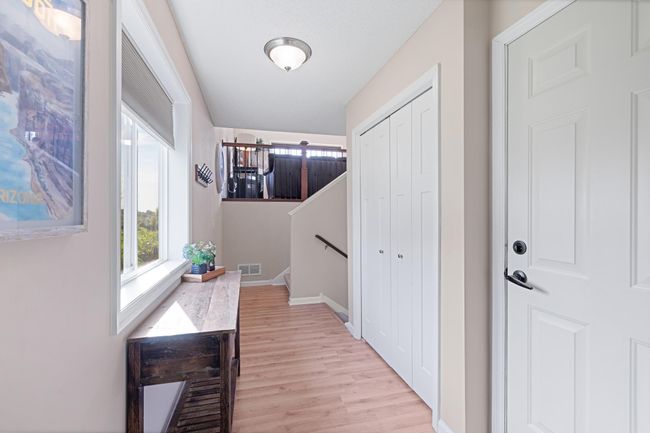 Large, bright foyer for welcoming guests and coming home after a long day. Coat closet with ample storage, direct garage access and stairs leading both downstairs to your basement and upstairs to your kitchen, dining and living room. | Image 4