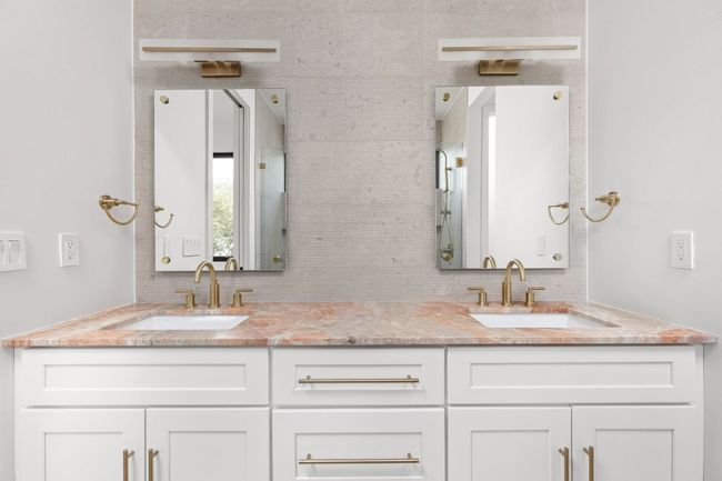 Full bathroom featuring double vanity and decorative backsplash | Image 23