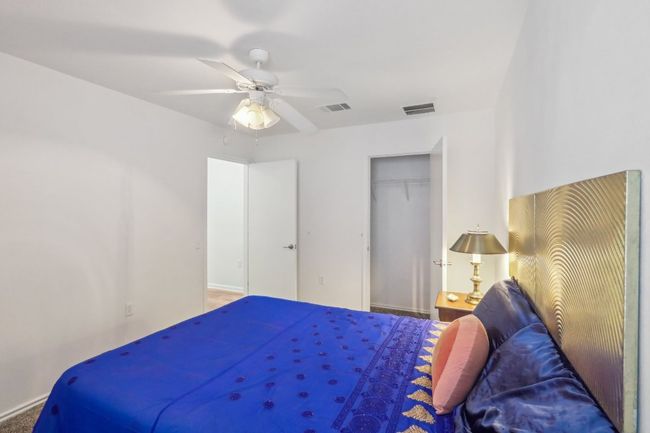 Bedroom with ceiling fan, visible vents, baseboards, and a closet | Image 16
