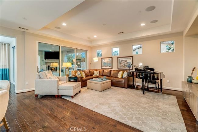 Coffered ceilings with surround sound speakers. Sliding glass walls to the outdoor kitchen and sitting areas. | Image 9