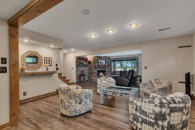The lower level offers a comfortable sitting area complete with a wet bar and space for game tables—perfect for entertaining | Image 27