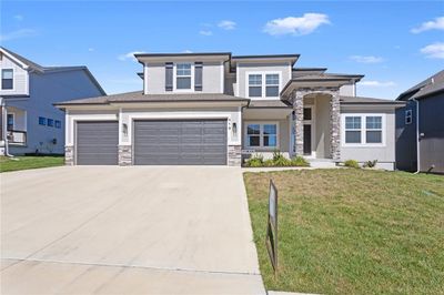 Prairie-style home featuring a garage and a front yard | Image 1