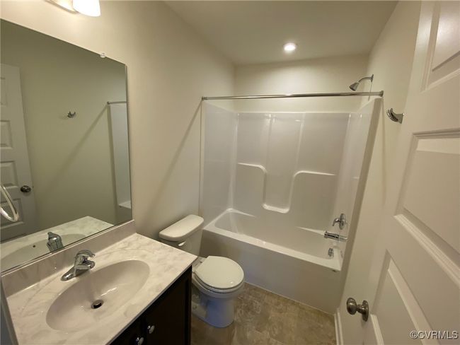 Bathroom featuring vanity, toilet, and bathing tub / shower combination | Image 30