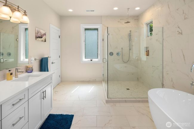 Enter the luxurious primary bath, with heated floors, oversized shower, and deep soaking tub. | Image 17