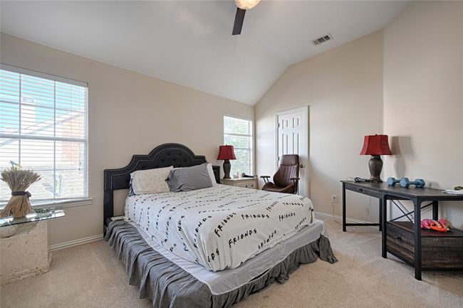 Bedroom featuring visible vents, vaulted ceiling, light carpet, and baseboards | Image 14