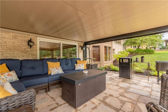 This is a view of the walk out basement area. The California doors open out to this covered porch with blinds that open and close. | Image 9