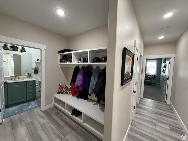 Mudroom featuring light wood-style flooring, a sink, and baseboards | Image 49