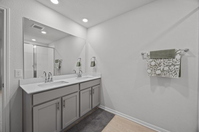 Full bath featuring double vanity, wood-look floors, and double vanity | Image 21