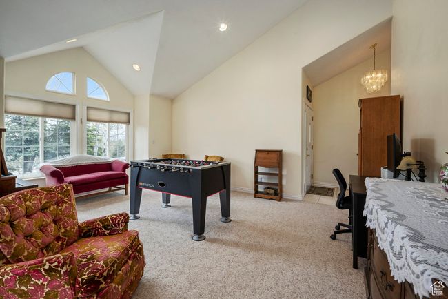 Playroom featuring carpet floors, recessed lighting, a chandelier, and high vaulted ceiling | Image 10